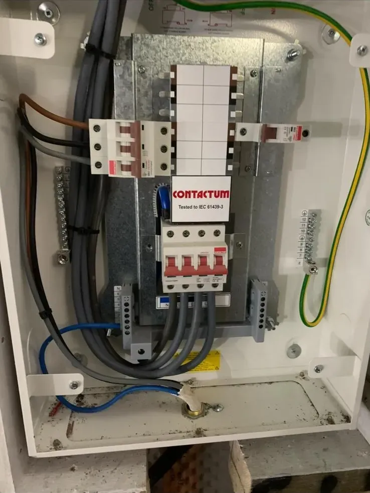 Internal wiring and circuit breakers inside a modern consumer unit fuse board.