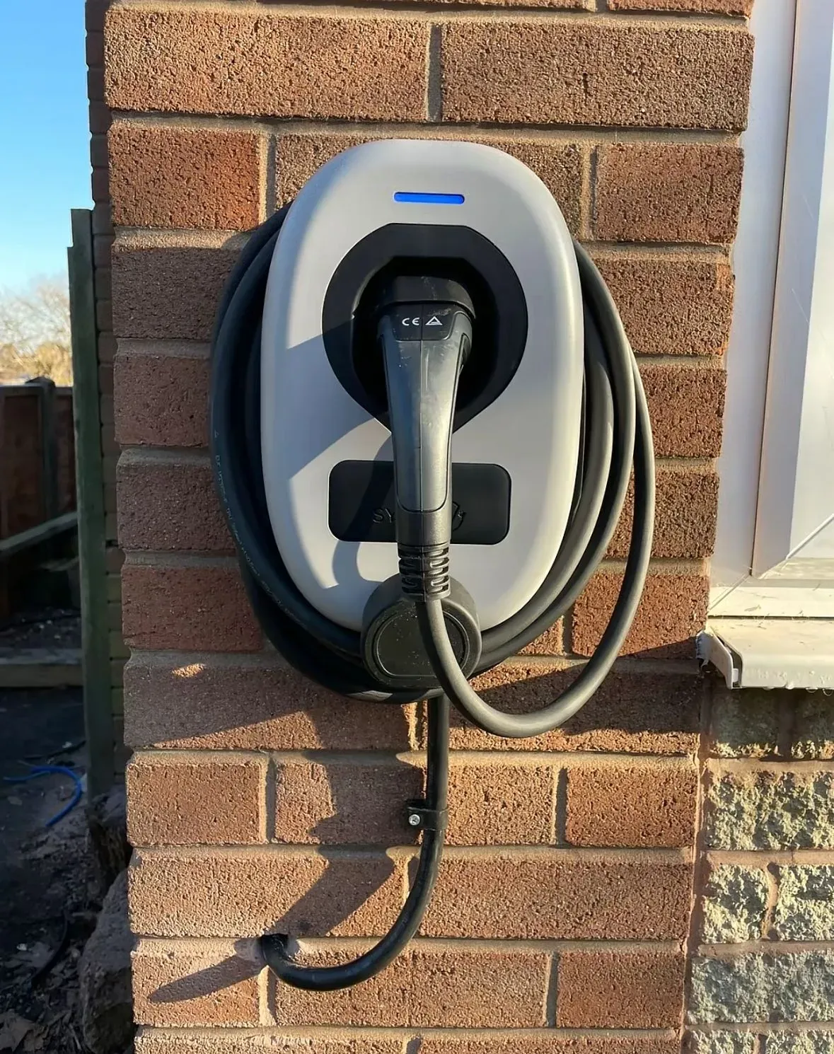 Professional domestic EV charger installation on a brick wall